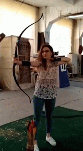 a person is practicing archery in a building