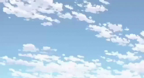 an airplane in flight, with a background of clouds