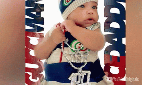 a po of a baby with necklaces on