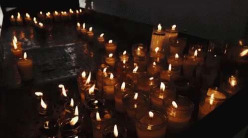 many lit up candles in different sizes and shapes