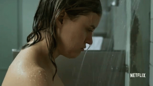 a girl in the shower is completely covered by water