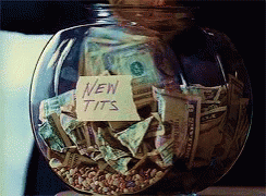 a clear glass bowl filled with money and notes
