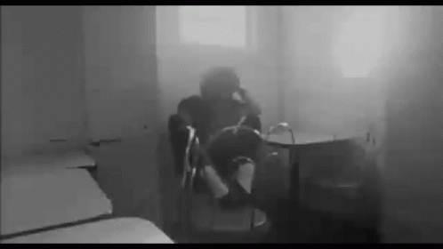 a blurry po of a person sitting in a chair