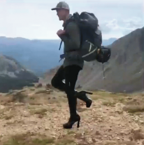 a person with a backpack is in the middle of a jump