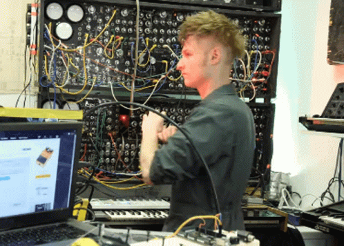 a man uses electronics to record his music