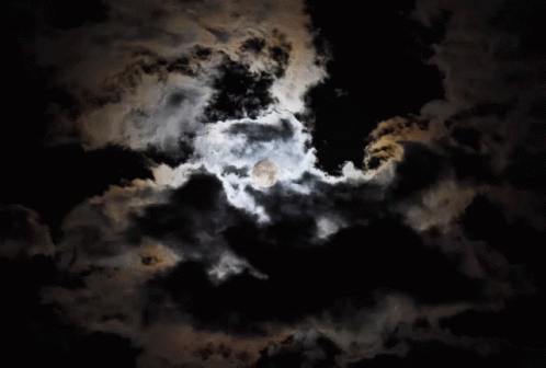 the moon is shining through dark clouds with no one on it