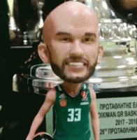 a person with a balding head and ball and trophy