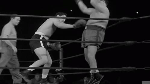 three men fighting with each other in the ring
