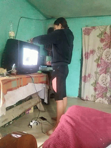 a man in a room with a tv set