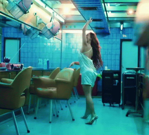 a woman dressed in white dancing in a building