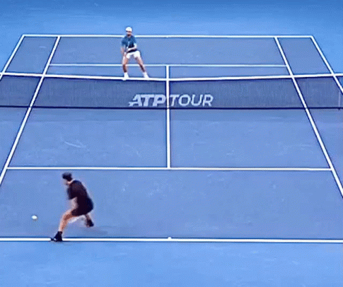 two men on a tennis court playing tennis