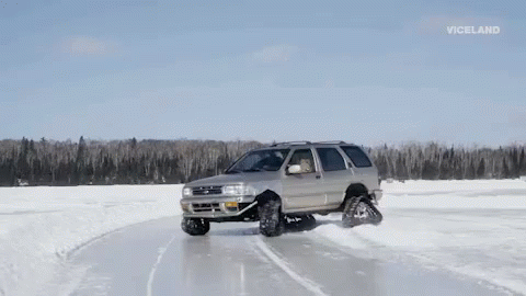the truck is driving on a snowy road