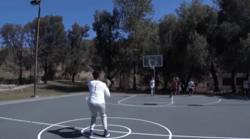 a basketball court that has several people playing on it