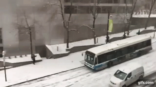 an old bus is going down the snowy street