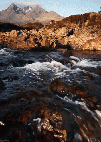 an image of a mountain stream running past some rocks