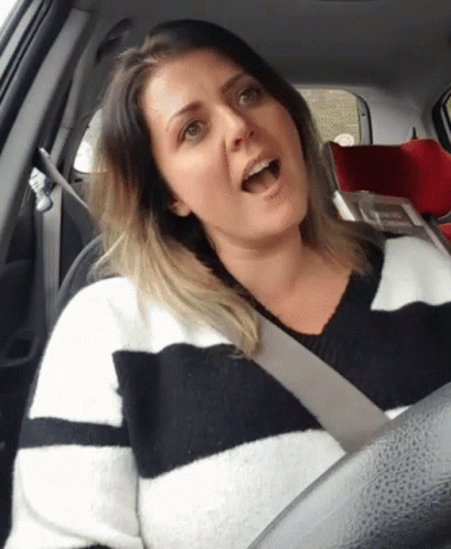 a woman in the back seat of a car being shocked
