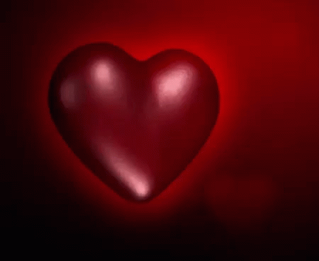 a heart shaped object illuminated in the dark