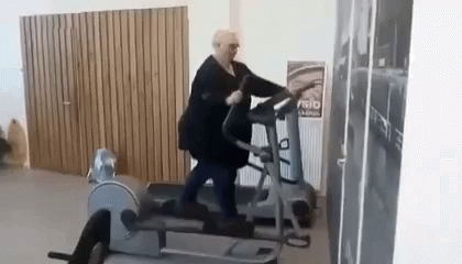 an elderly gentleman using a treadmill in a gym