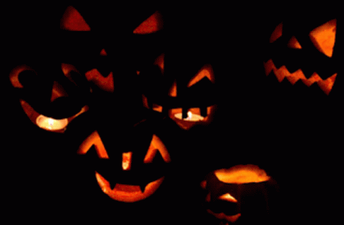 many blue jack o lantern pumpkin faces on a black background