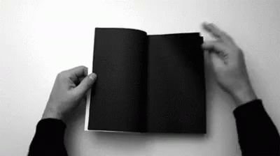 a person holding an open book up to their face