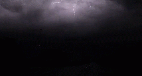 a dark background with lightning bolts that are in the dark