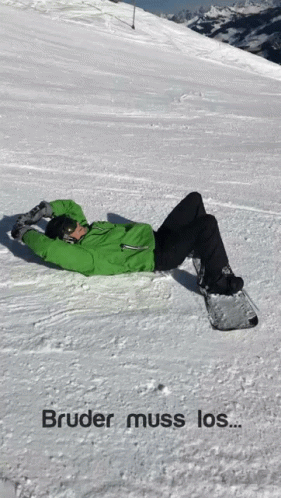 a snowboarder fell down on the ground with his snow board