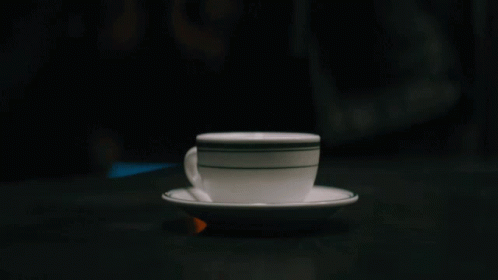 a white cup sitting on top of a saucer