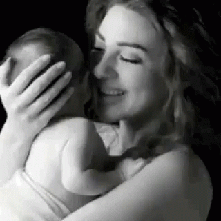 black and white po of a woman holding her newborn baby