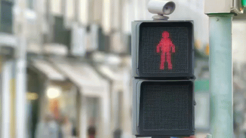 a pedestrian signal with blue cross walk signs