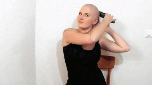 a woman is blow drying her hair with a blue blow dryer