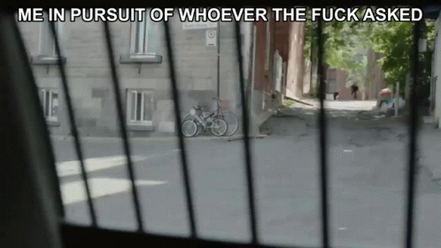a po of an alley and bike through the window of an apartment
