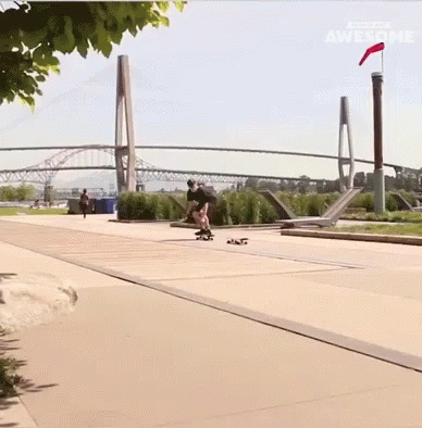 a man is skating along a concrete path