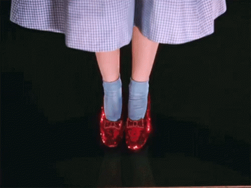 a closeup image of a person wearing blue heels and socks