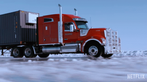 this truck has an enclosed trailer and is in the snow