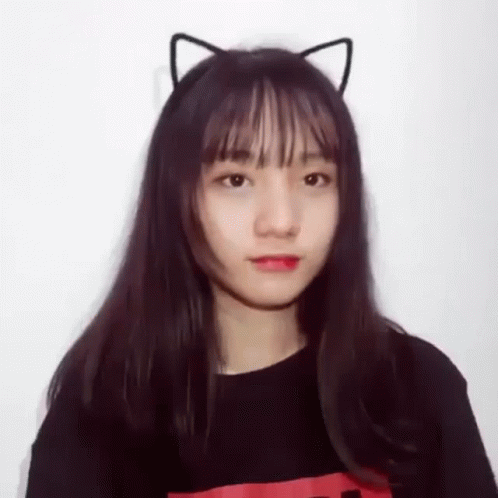 a person wearing cat ears on their head and a blue shirt