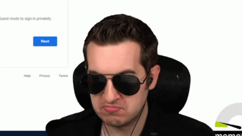 there is a man with sunglasses on in front of a computer screen