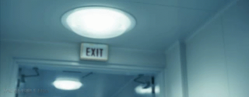 an exit sign hangs on the wall by the doorway