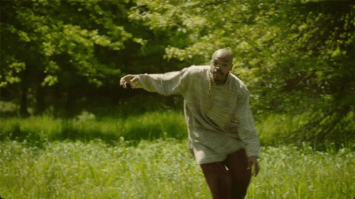 an old man throwing a frisbee in a field