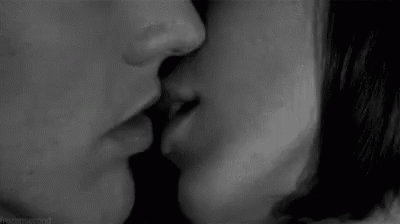 the woman is kissing the man on the lips