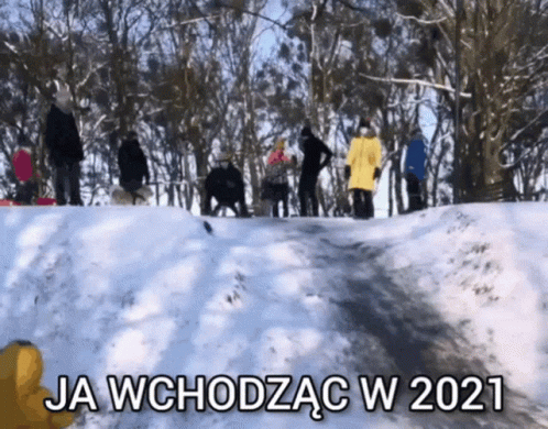 several people walking up a snowy hill in a line
