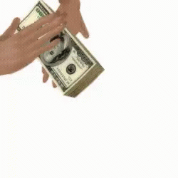 two hands that are holding money in one hand