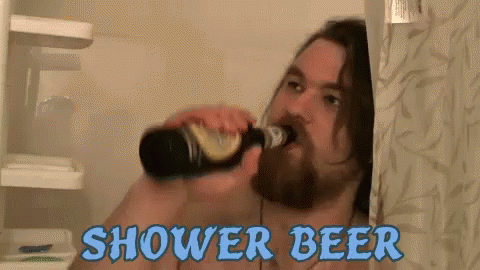 a man drinking beer while brushing his teeth