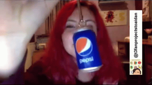 a lady is holding a pepsi can in her hands
