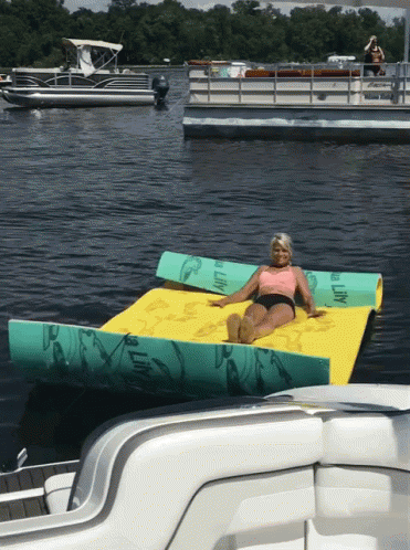 there is a person lying on an inflatable floating boat