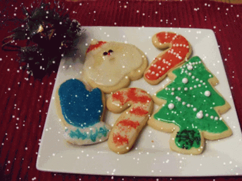 decorated cookies are displayed on a white plate