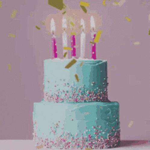 a colorful cake with candles that are sprinkled