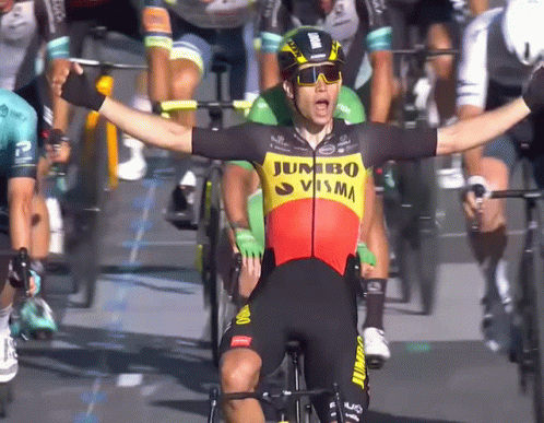the professional cyclist has his arms wide open
