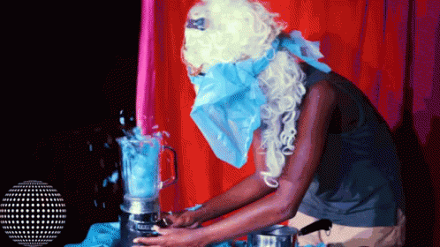 blue man in a costume is putting a blender in the cup
