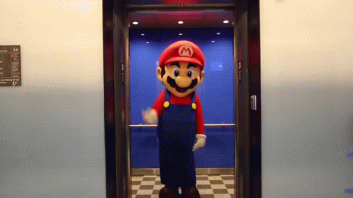 the mascot, dressed in overalls and a hat, is on display in a hallway