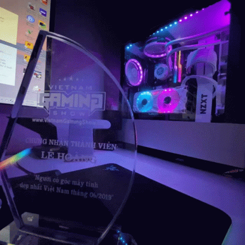 a glass trophy sits in front of a computer